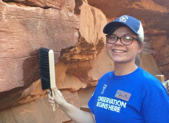 Kiara "Kiki" Serantes, a SCA Cultural Resources Intern at Zion National Park, cleans up graffiti in one of the park's famous slot canyons.